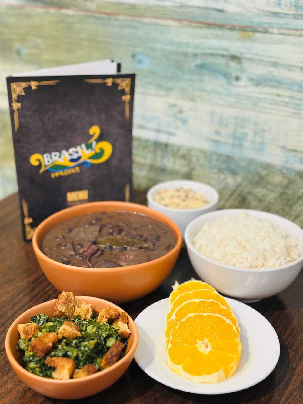 Black beans, rice, farofa and greens at Brasil Burgers, with the menu behind